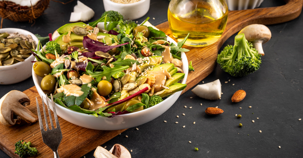 Healthy salad with leafy greens, avocado, seeds, and nuts that may help support healthy blood sugar levels