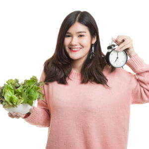 woman with clock and salad 