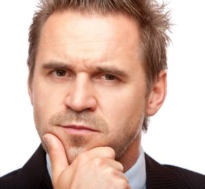 Businessman looks contemplative because of a problem