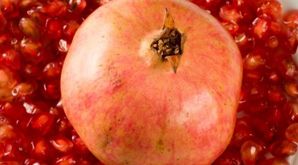Pomegranate on red pomegranate grains