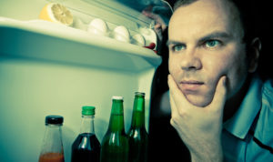 man looking in refrigerator