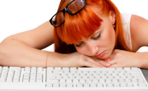 Girl sleeping in front of the keyboard