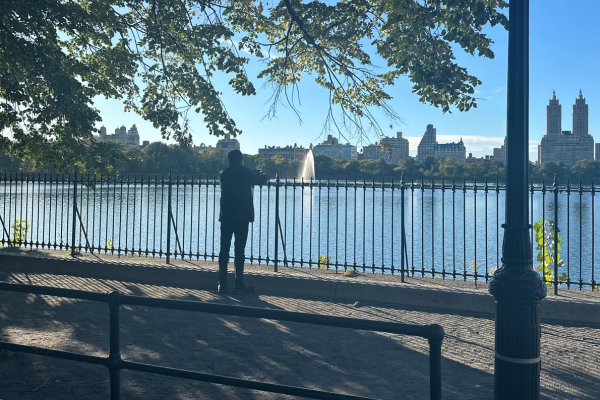 Person relaxing by the reservoir in Central Park