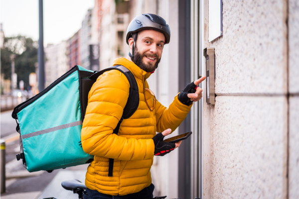 Delivery person bringing healthy groceries to a New York City apartment