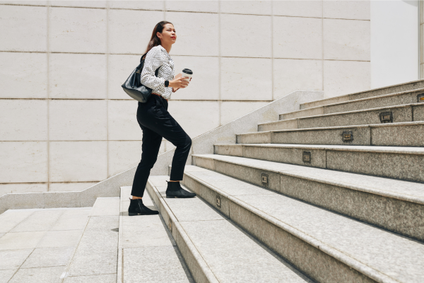 Person walking up outdoor stairs in New York City, showing how everyday movement supports healthy living tips from a NYC nutritionist
