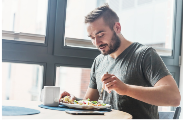 Man eating a balanced breakfast to support metabolic health and blood sugar balance