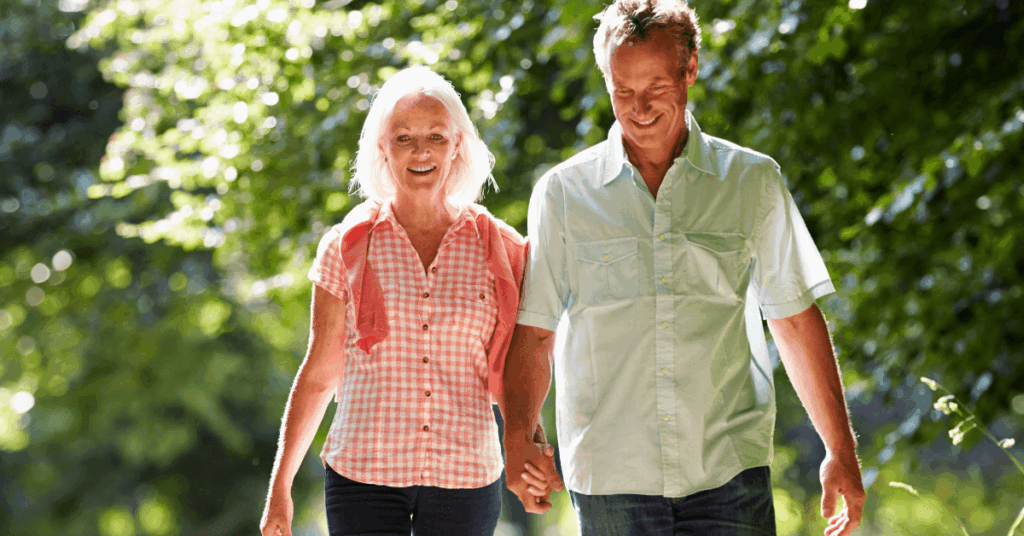 Older couple walking together as part of a healthy lifestyle to help reverse prediabetes