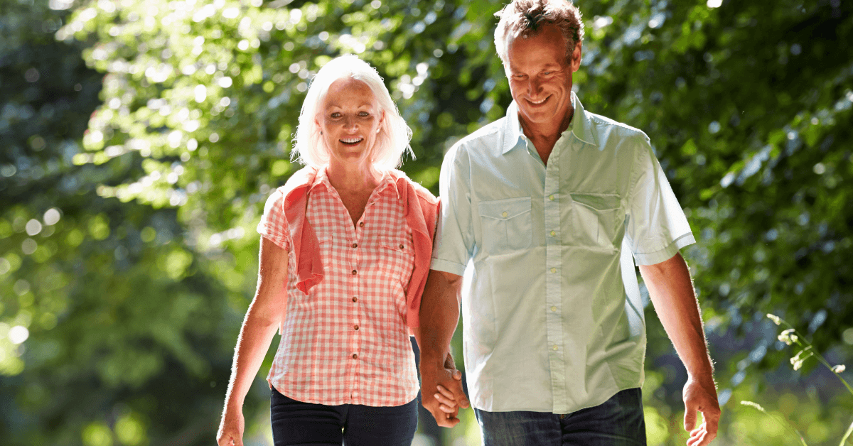 Older couple walking together as part of a healthy lifestyle to help reverse prediabetes