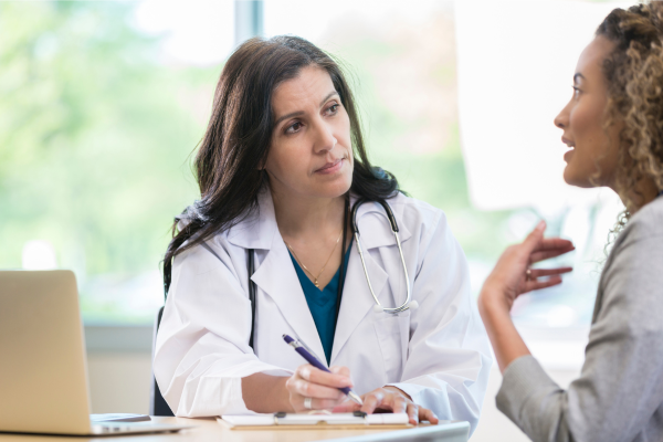 A healthcare professional discussing GLP-1 and weight loss treatment options with a patient.