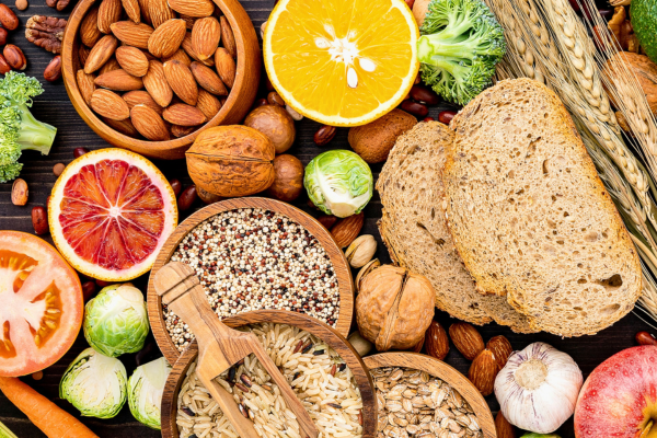 High-fiber foods including whole grains, nuts, fruits, vegetables, and seeds that support digestive health